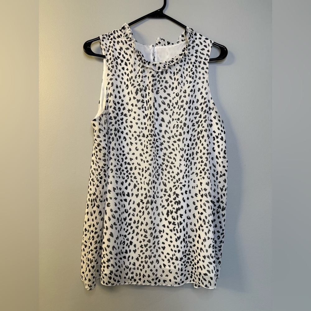 Black and white animal print top with ruffled collar. Size L.